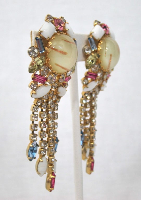 Featured is a pair of vintage Hobé clip earrings. All prong-set stones in a gold tone setting.

3