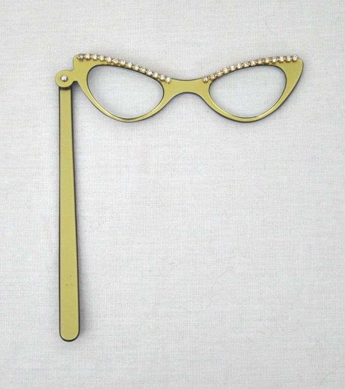 Featured is an elegant gold Lucite lorgnette from the 1950s. Sparkling rhinestone accents. Filled with prescription lenses.

Width: 4.75