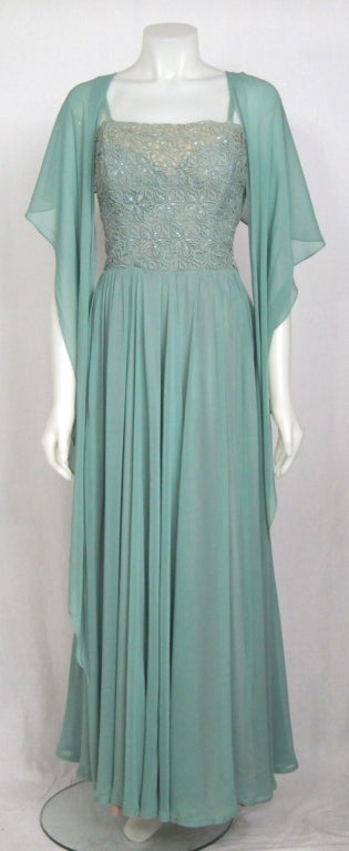 FABULOUS OLD HOLLYWOOD MUTED SOFT BLUE FLOWING CHIFFON. RHINESTONE EYELET BODICE WITH  ATTACHED SHAWL ,TRAIN. 
Bust 34