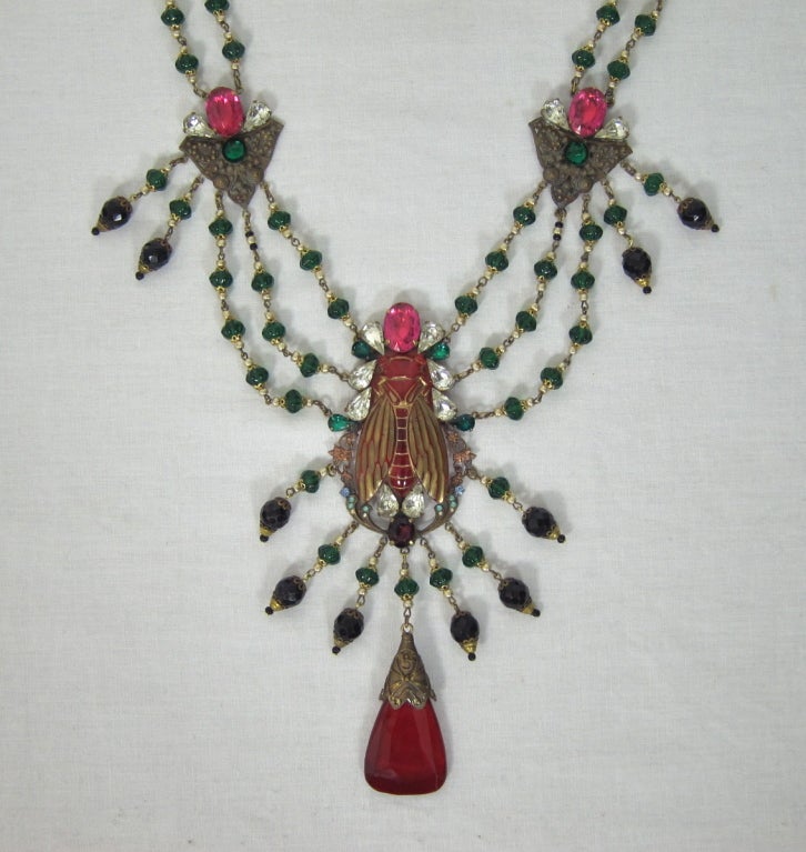 Featured is an amazing antique necklace from the Czech Republic, made during the Art Nouveau period. The centerpiece is a large red carved glass bee with dark gold accents. It is surrounded with teardrop rhinestones, all foiled and prong-set.