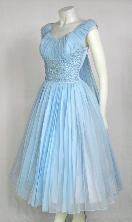 VTG 1950 BLUE CHIFFON SHELF BUST SOUTACH RHINESTONE WAIST PARTY WEDDING DRESS. 
The fabric is a baby blue  ombre nylon with a layer of tulle and another layer of acetate.  The waist is gorgeous with soutache ribbon, flowers and rhinestones. Metal