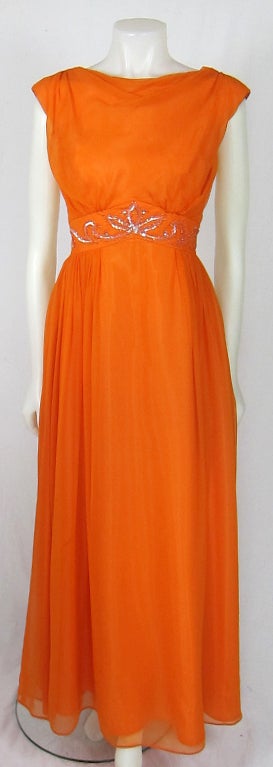 This is an amazing  1960's flowing neon orange chiffon maxi dress  with sequin waist.  It is fully lined and has a metal zipper.. A true beauty!

Bust 34