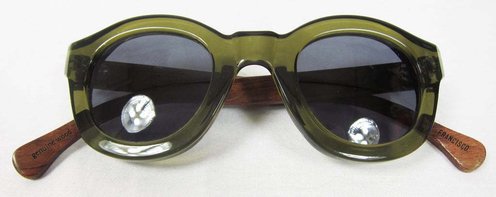 Featured is a beautiful example of skilled artistry in optical wear. These 1940s styled sunglasses were designed by Original Timber Co. of San Francisco and manufactured in France/Italy.

Clear olive green frames with polished and painted wooden
