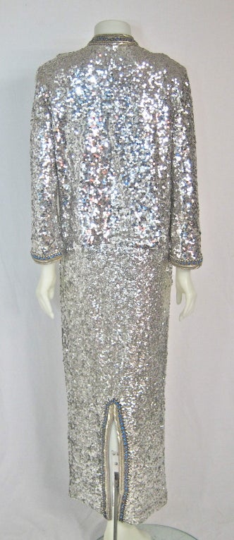 Exquisite  1960's Silver Sequin and blue beaded formal Gown with metal zipper and matching lined  jacket This used to belong to a former High Fashion Model. ( private). It has some stretch to it to fit the body perfectly
Dress:
Bust 34