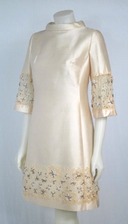 Gorgeous shift dress of ivory silk and beaded lace by Jean Lutece. Made in Hong Kong. Nylon zipper back zipper.

Bust:  36