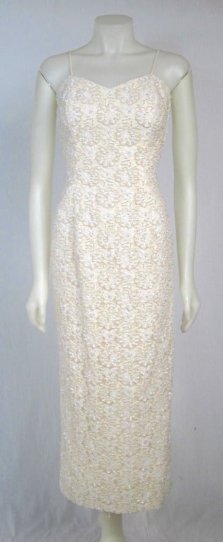 This is a beautiful Lace Column dress heavily beaded with faux pearls and iridescent sequins.  Spaghetti straps, full lined, padded cups ( easy to take out if need be)   back slit. Excellent Condition.
Bust: 34