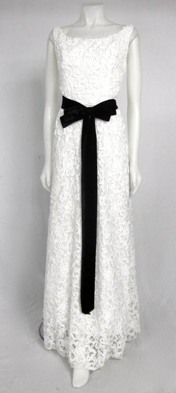 A true beauty by famous Emma Domb. Simple elegance made of  ribbon lace with  black Sash. Has a layer of tulle and  is lined. It has the slight fullness with the back  gently flowing on the floor .
 Ribbon can can be changed. We have several sashes