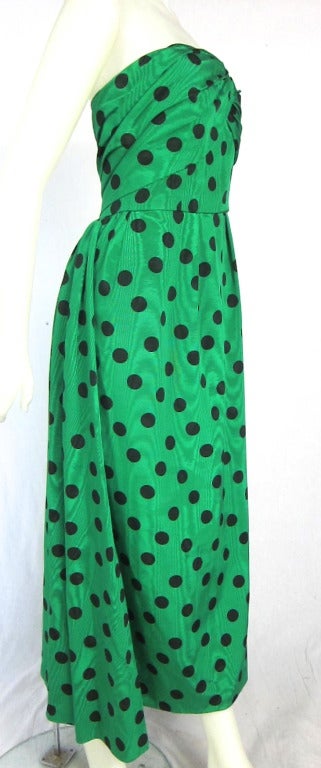 This is a GREAT dress! Green Moire  black pokla  a dots. Boning  int the bodice and fully lined. It has a lovely train and a matching jacket reversed pattered. Self covered buttons, loops and  hook closures This dress is very flattering  This could