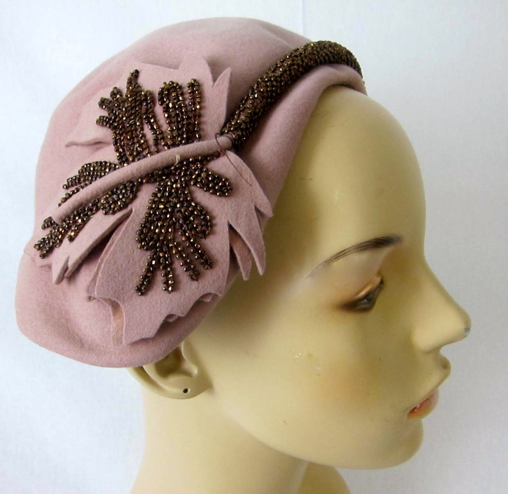 Adorable nude pink hat with felt maple leaves and copper beading. Great to wear to a wedding! 
It is wonderful how one side rests higher than the other. Sweet 
15