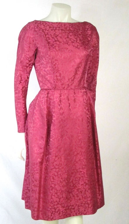 Long sleeves Fuschia Satin Brocade with sexy scooped back, fitted waist with white tulle underskirt that gives the skirt a nice form.  Bright simple elegance!  Perfect for attending a wedding!   Very Mad Men! 

Bust: 36