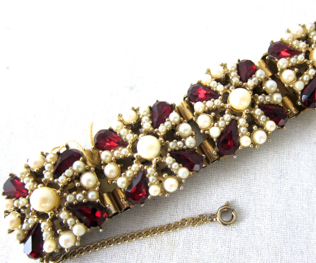 Very rare chunky red ruby glass and seed pearl bracelet with safety chain.
7.5