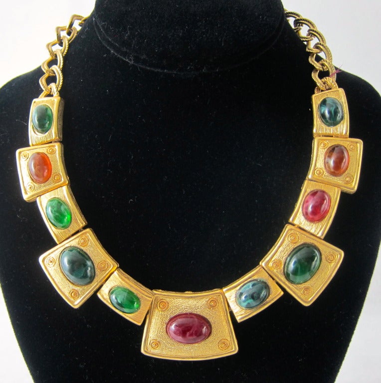 Sophisticated modernist necklace of a gold tone metal with green and amber lucite cabochon stones.   Dress it up or down! 

Length 18