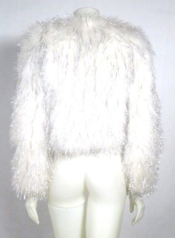 Ready for New Years Eve? Perfect fluffy Ostrich Feather and silver tinsel long sleeved bolero jacket. Two hook eye closures. SUPER FUN! 

Bust: 38