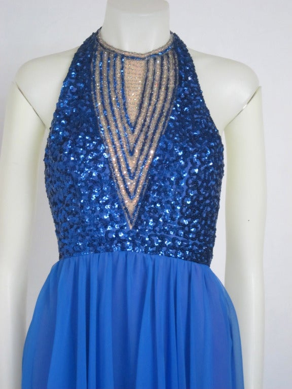 Gorgeous Blue chiffon and blue sequin halter open back bodice long formal dress. Lined...simply stunning! 

Bust: 32