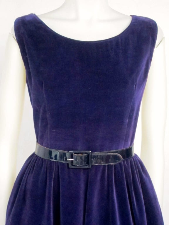 Beautiful Purple Velveteen dress with pockets, side metal zipper and matching jacket. Jacket has removable shoulder pads. Belt not included. (it is not original to the dress and is damaged)

Dress: Bust: 40