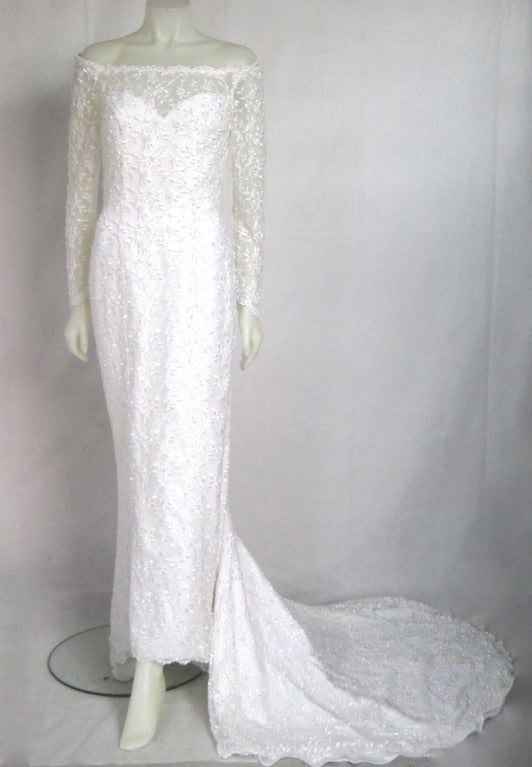 Beautiful Oleg Cassini off shoulder wedding dress. Sheer White floral with pearls. Lovely train. Fully lined. Zipper and self covered back buttons. Gorgeous!

Size 8