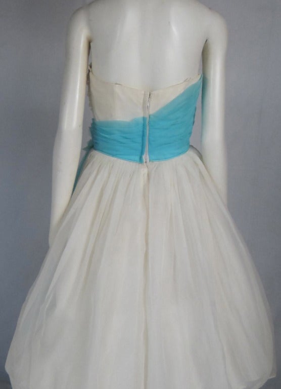 Fresh and Alive! This is a strapless with boning nylon Chiffon ballerina dress with Turquoise nylon chiffon and vintage flower side sash. Metal zipper, tulle and acetate underskirt. The bodice looks yellow..IT IS  white....just the