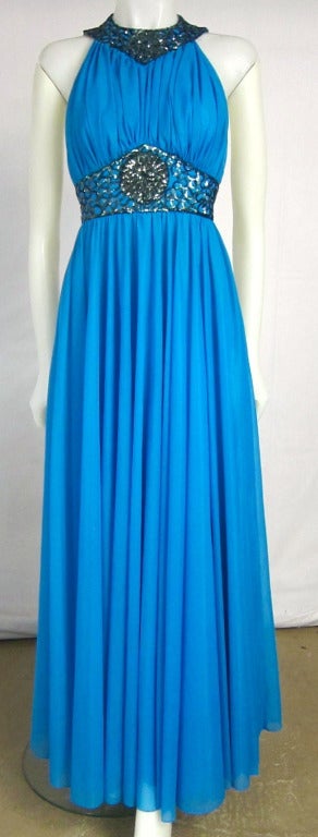 Grecian Goddess dress. Aegean Sea Blue nylon  Chiffon Ruche bodice loaded with sequins front and back fully lined Racer Cut.   Incredible Dress! Red Carpet Worthy! 

Size 8

Bust:  30