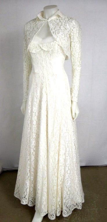 Gorgeous 1950s All lace shelf bust Wedding Dress Strapless with  boning  in the bodice.., metal zipper silky satin lining. The bolero has long sleeves with buttons and a peter pan  scallop edge collar. Gorgeous hard to find Wedding Dress.