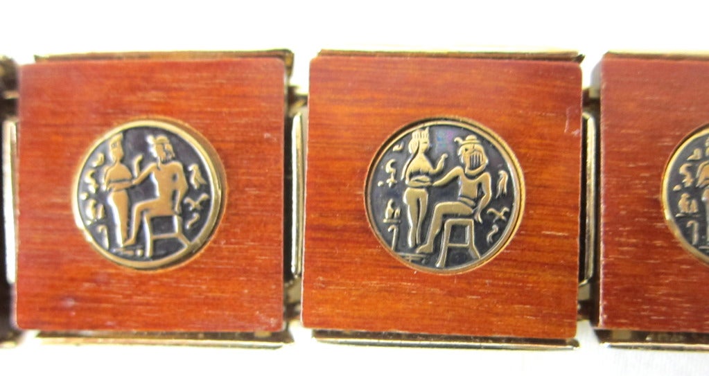 Fabulous contemporary Mid Century Wood Veneer with Egyptian Motif bracelet and matching clip on earrings. 

Bracelet  6.5