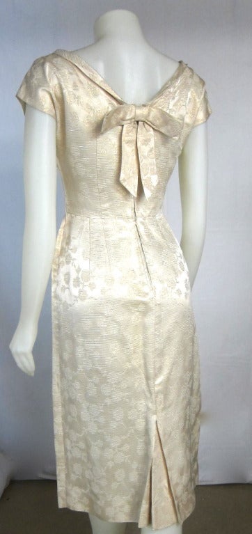 1960s Gold Metallic Rose Back Bow Wiggle Cocktail Dress For Sale at 1stDibs