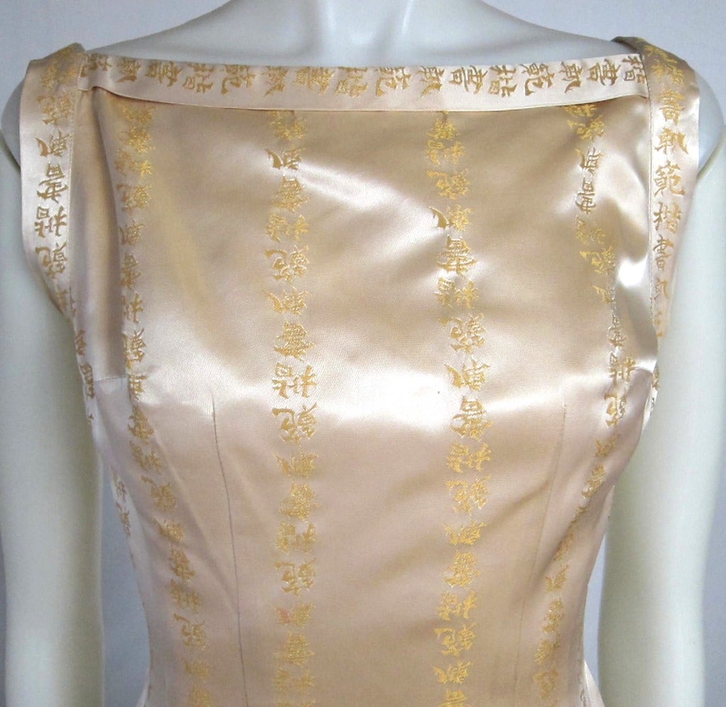 Gorgeous Mad Men dress!  Light gold  satin with Chinese Letters. Has side slit gorgeous v back.  Has metal zipper.
Bust: 34