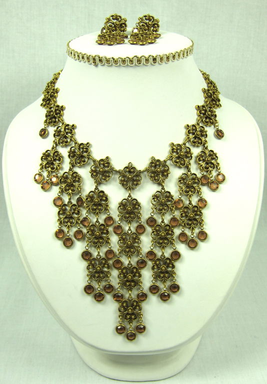 This is a fabulous large chandelier dangle necklace and earrings made by Goldette in the Victorian Style.<br />
The gold tone metal has a lovely design with light topaz glass dangles. The earrings  dangle, sparkle and have spring to open and