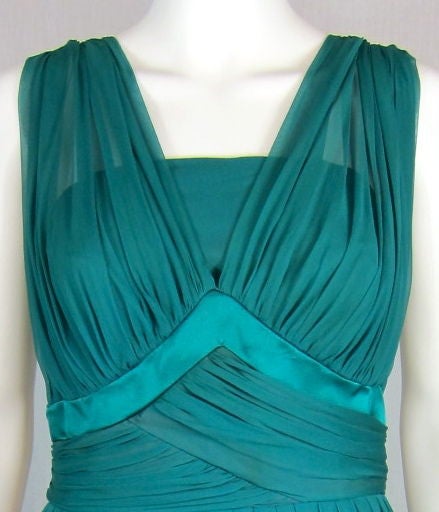 This is one of the most beautiful Mad Men dress I have seen!<br />
The color in pics look a little blue, however it is more of a green. Metal zipper.<br />
The dress is chiffon with satin bust trim. The neckline is very beautiful as well has the