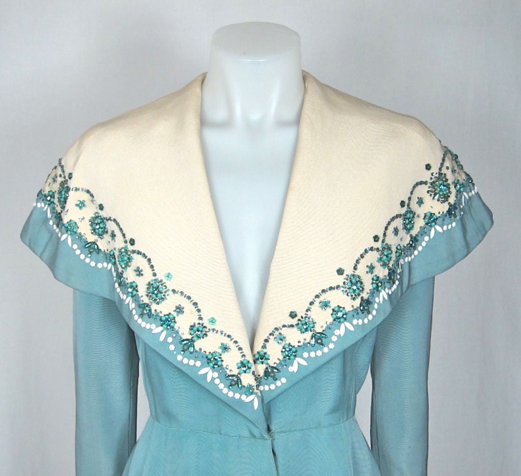 Featured is an exquisite by Royal Appointment  Hartnell evening coat from the 1950'S   It is the short version of the one in the exhibition  in London. Please see link.
