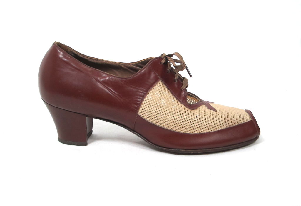 Featured are a classic pair of spectator shoes from the 1940s. The vamp is made of fine cream-colored mesh, with a leather accented cut out. The original twill ribbon laces are strong. <br />
<br />
Interior length: 10 3/8
