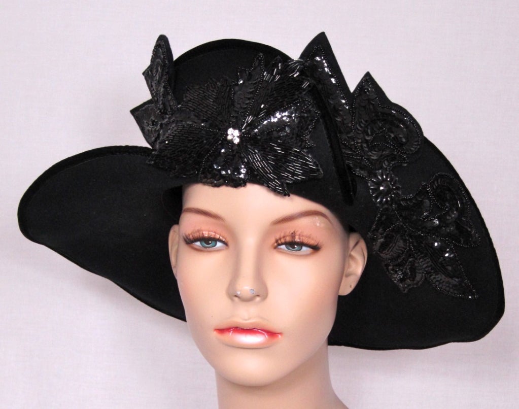 Going to a Kentucky Derby night party? This is the hat for you!
Fantastic shape.Massive jet black bugle bead and sequin flowers with rhinestone center. This could look beautiful with a tight long sleeved wiggle dress or tight black jean and soft