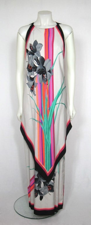 This is a fantastic two  piece outfit. The maxi dress is handkerchief  layer caftan that is sleeveless. The arm holes cutIt has a matching poncho. Beautiful resort wear or a beach wedding. Feel the warm breeze moving the silk!
It has a sheer