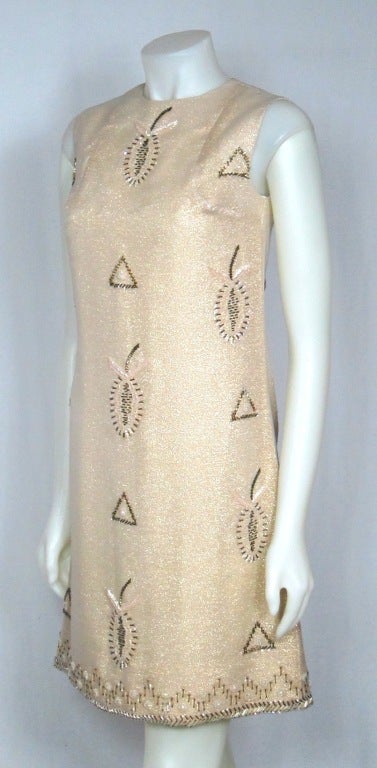 This is an amazing dress!  The fabric is shimmering gold with beaded pineapple motif. The color of the beads are iridescent white and gold . The dress is lined in silky material. <br />
It has a metal zipper along the back. This is a great party