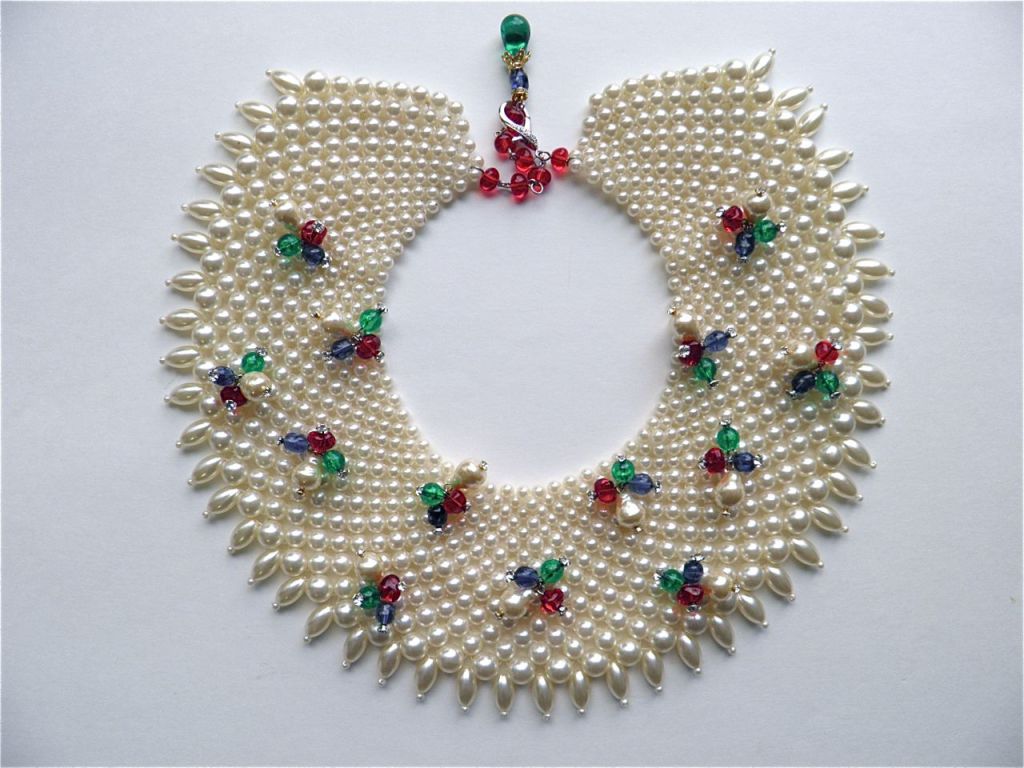 A wonderful vintage pearl bib that's been dipped in fruit salad and dripping little bunches of vintage 'ruby emerald sapphire ' beads. A great size, light as a feather and the total look achiever. Three inches deep and can fit all necks. Perfect CZ