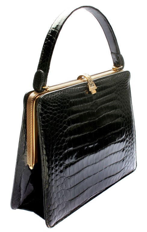 This is a  very clean and stylish handbag with interesting  hardware and good quality skin.<br />
The width of the bag is 10 3/8