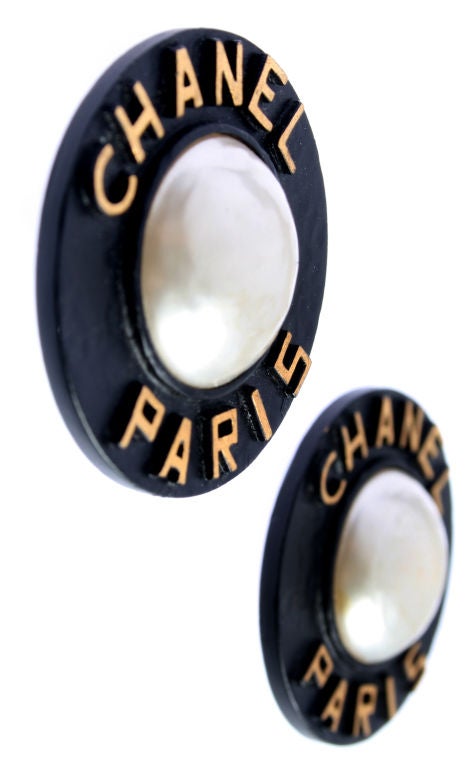 These large clip on earrings are wonderful.  The black contrasting with the white of the faux Mabe pearl and gold lettering is really clean and graphic.