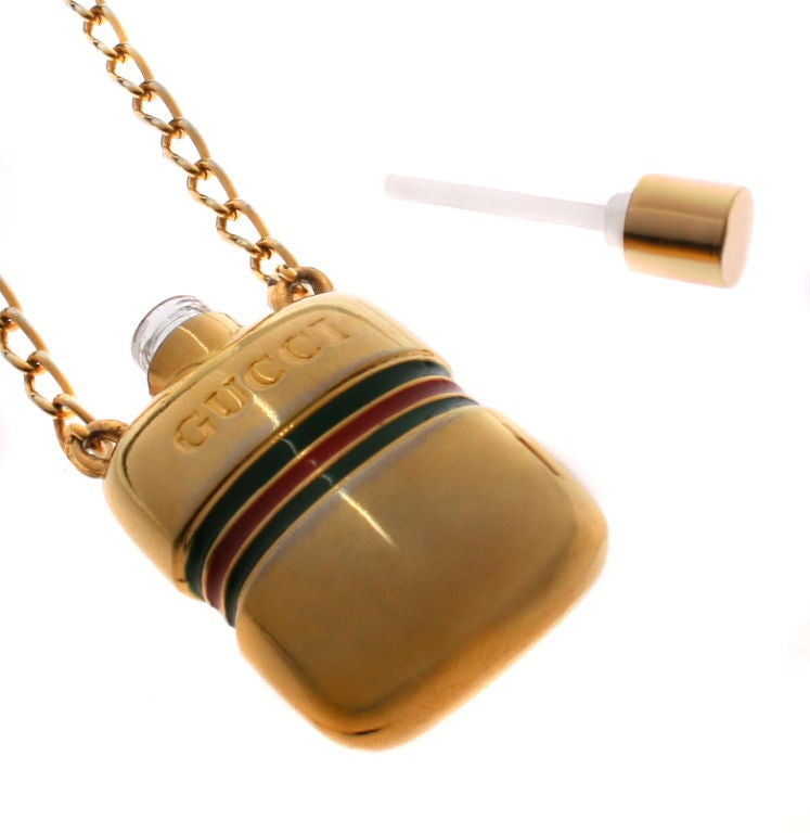 This is a fun Gucci necklace that you can actually fill with your favorite perfume! It is gold plated with Gucci green and red enameling.<br />
<br />
*Measurements*<br />
The perfume bottle measures 1 7/8