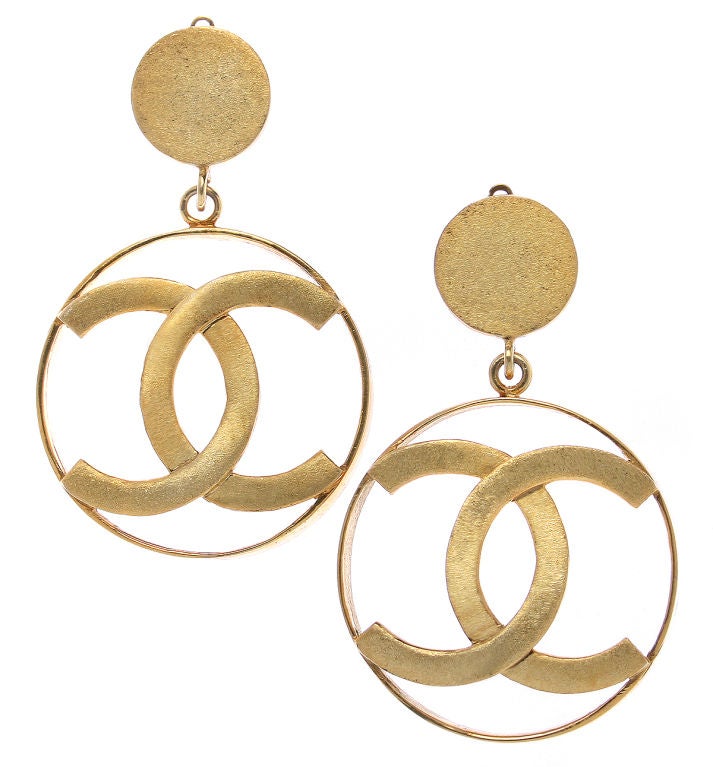 These are quite fun Chanel logo earrings. They have a brushed gold finish.