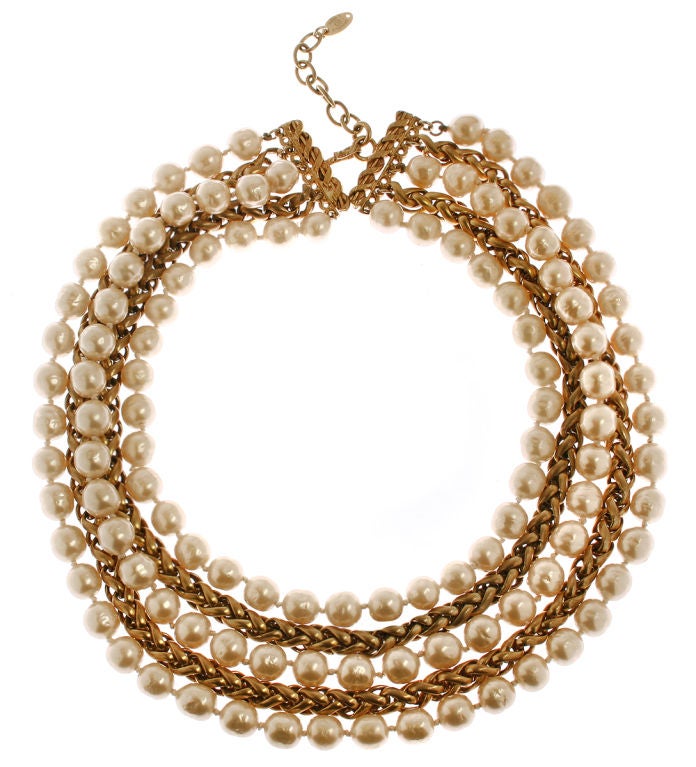 This is a sophisticated and elegant muti strand necklace having an interesting chains in a warm gold tone interspersed with three strands of pearls.

*Measurements*
The inner strand measures approximately 15 1/2"l; when worn the 4 strands
