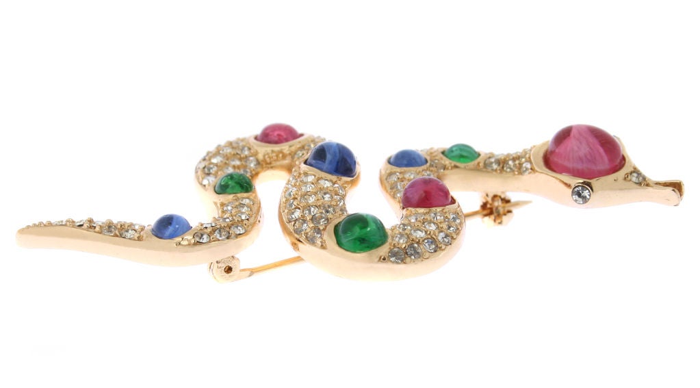 This is a fabulous Christian Dior brooch with multi colored poured glass cabochons.