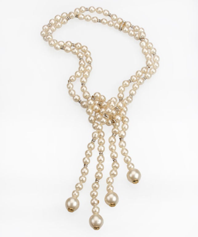 This is a fabulous Chanel pearl double strand necklace accented with rhinestone rondels. A beautiful versatile  lariat, this necklace can be wrapped twice to wear as a chocker, worn as shown in the photo, or worn hanging down the back.  The overall