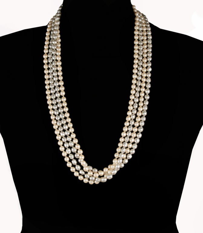These are two wonderfully versatile long Chanel opera length pearl necklaces in silver grey and warm natural pearl color. They are stunning when worn doubled, opera length or knotted. <br />
Each strand of pearls measures 67