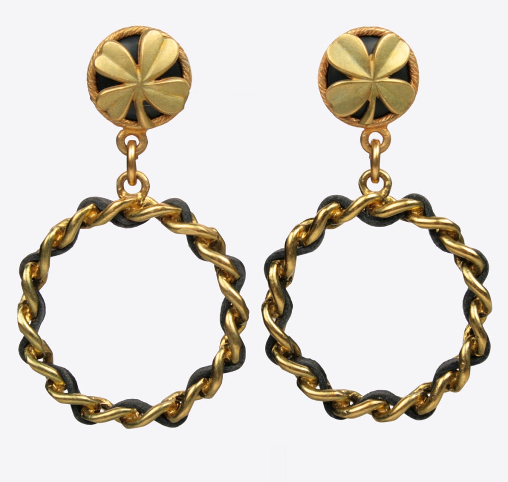 Edgy hoop earrings laced with black leather by the house of Chanel.