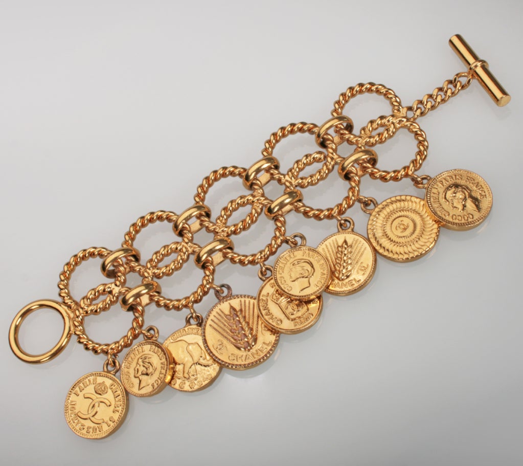 This is a great, strong CHANEL bracelet adorned with dangling coins.  They  all have the CHANEL name and a design on both sides.