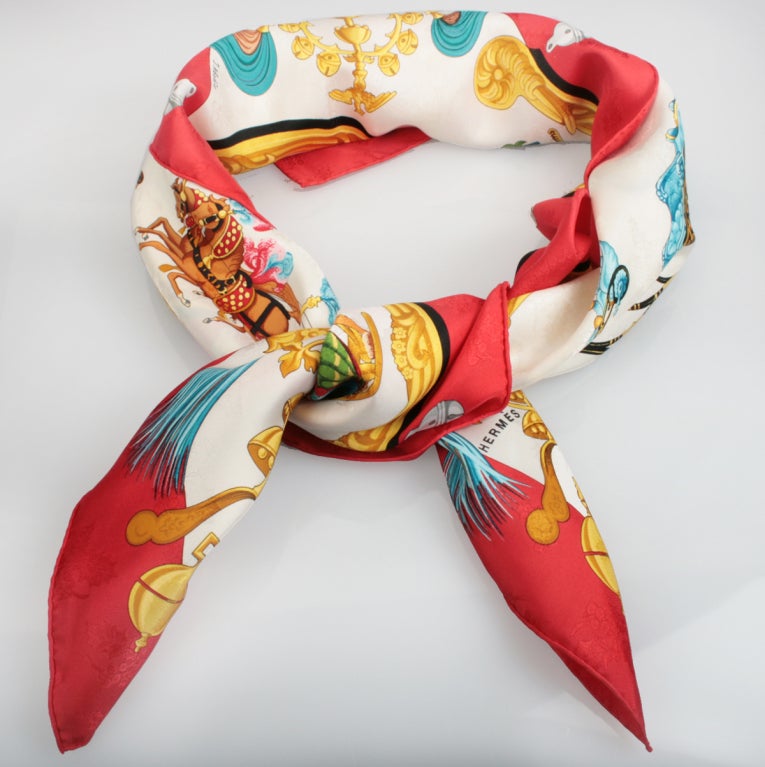 This is the classic PLUMES et GRELOTS, Feathers and Sleighs, designed by Julia Abadie, and it is one of the most popular Hermes Holiday scarves and has become an all time favorites among collectors and Hermes scarf lovers.

This design depicts