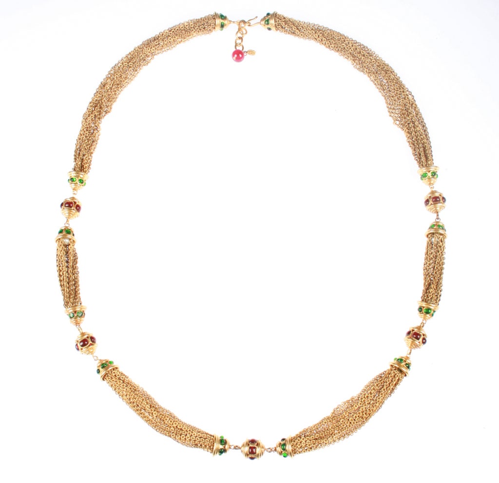 This is a really fabulous and unusual necklace, and a great layering piece. The constuction is really nice.  The chains are accented by beads with red and green glass cabochons. The extension allows the necklace to be enlarged from 37