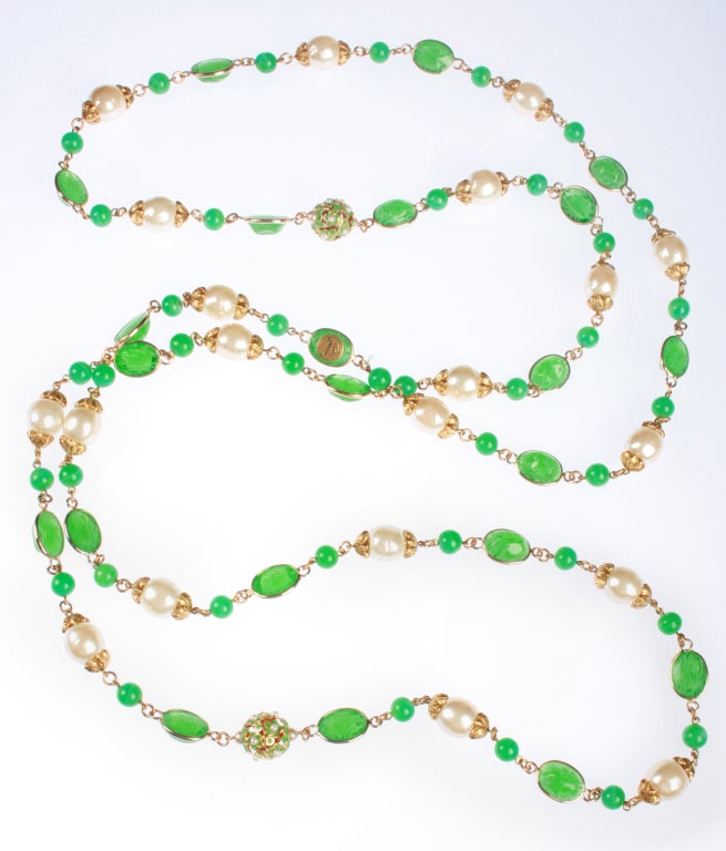 This is a beautiful necklace having two different green glass elements highlighted with pearls. Also, there are two beads comprised of many green petals with tiny pearl centers, very beautiful and unusual.   A continuous length of 72
