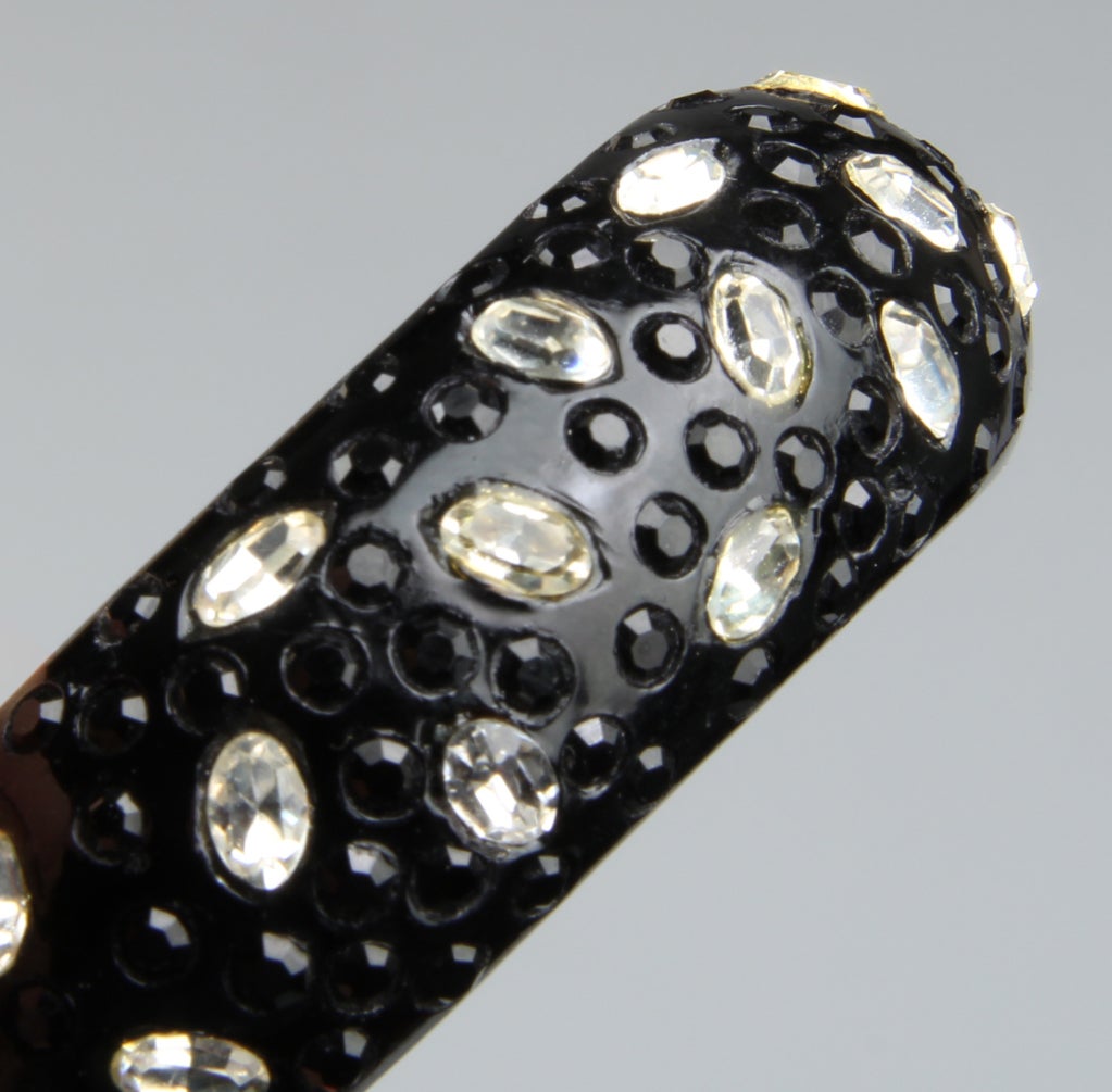 This chic resin clamper bracelet is embedded with both clear and mirrored rhinestones. 
The inner circumference is 6