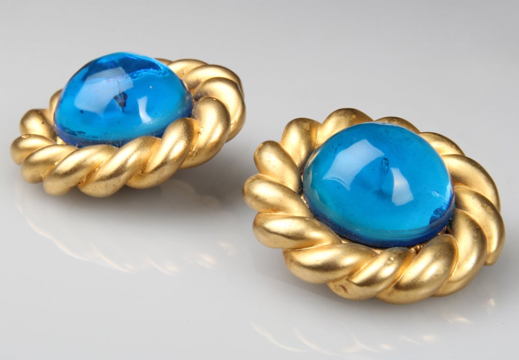 For those that love this color blue, these large earrings with a poured glass center cabochon are for you.   Marked on the back..... CHANEL, Made In France