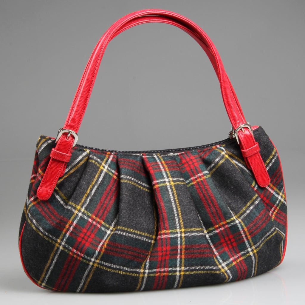 This is a fun Tartan wool  handbag embellished with appliques of felt flowers and beads. It has a large red interior with one zippered compartment.